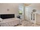 Cozy bedroom with wood-look floors, neutral walls, and natural light at 12358 Lavender Loop, Bradenton, FL 34212