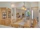 Bright dining room showcasing hardwood floors, an open layout, and views of the home office at 12358 Lavender Loop, Bradenton, FL 34212
