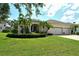 Charming single-story home featuring a manicured lawn, mature landscaping, and a three-car garage at 12358 Lavender Loop, Bradenton, FL 34212