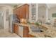 Well-equipped kitchen showcasing granite countertops, stainless appliances and wooden cabinets at 12358 Lavender Loop, Bradenton, FL 34212