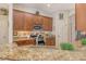 Kitchen featuring granite countertops, stainless steel appliances, and rich wood cabinetry at 12358 Lavender Loop, Bradenton, FL 34212