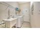 Functional laundry room featuring sink, washer, dryer and storage at 12358 Lavender Loop, Bradenton, FL 34212