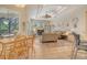 Open-concept living room with hardwood floors, a modern ceiling fan, and ample natural light at 12358 Lavender Loop, Bradenton, FL 34212