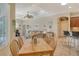 Open-concept living and dining area filled with natural light, neutral tones and modern furnishings at 12358 Lavender Loop, Bradenton, FL 34212