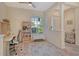 Bright home office featuring hardwood floors, neutral walls, a large window, and a desk area at 12358 Lavender Loop, Bradenton, FL 34212