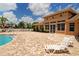 Community clubhouse with pool, lounge chairs, outdoor brick patio, and playground for Gathering fun at 12358 Lavender Loop, Bradenton, FL 34212