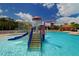 Fun splash pad with waterfall and slide feature in the community pool area, designed for kid-friendly entertainment at 12358 Lavender Loop, Bradenton, FL 34212