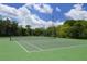 Well-maintained community tennis court with green surface and clear white lines for competitive play at 12358 Lavender Loop, Bradenton, FL 34212