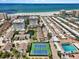 Beautiful aerial view of tennis courts, pool, and condos near the beach at 1255 E Peppertree Dr # 507, Sarasota, FL 34242