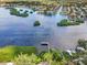 Stunning aerial view of waterfront property with private dock and lush landscaping at 1255 E Peppertree Dr # 507, Sarasota, FL 34242