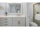 Well lit bathroom features modern vanity, white countertop, sink, and walk-in shower with glass doors at 1255 E Peppertree Dr # 507, Sarasota, FL 34242