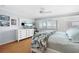 Inviting bedroom features a light blue wall paint, wood floors, and large windows with shutter-style blinds at 1255 E Peppertree Dr # 507, Sarasota, FL 34242