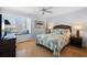 Bedroom features a comfortable bed, wood floors, a dresser, and a cozy window seat at 1255 E Peppertree Dr # 507, Sarasota, FL 34242