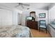 Bedroom features a comfortable bed, wood floors, a dresser, and a cozy window seat at 1255 E Peppertree Dr # 507, Sarasota, FL 34242