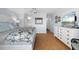 Comfortable bedroom features a plush bed, wood floors, and a white dresser with a mounted TV at 1255 E Peppertree Dr # 507, Sarasota, FL 34242