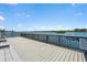 Waterfront deck with views of the bay, featuring wood railings and ample space for relaxing and enjoying the scenery at 1255 E Peppertree Dr # 507, Sarasota, FL 34242