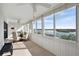 Sunroom with a glass dining table setup offering a stunning water view at 1255 E Peppertree Dr # 507, Sarasota, FL 34242