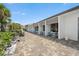 Exterior view of condos with a walkway, palm trees and outdoor tables at 1255 E Peppertree Dr # 507, Sarasota, FL 34242
