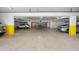 Clean garage features multiple parking spaces with yellow pillars and clearly marked spots at 1255 E Peppertree Dr # 507, Sarasota, FL 34242