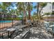 Outdoor grilling area with picnic tables and well-maintained landscape at 1255 E Peppertree Dr # 507, Sarasota, FL 34242