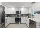 Modern kitchen with stainless steel appliances, white cabinets and gray backsplash at 1255 E Peppertree Dr # 507, Sarasota, FL 34242