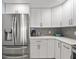 Clean kitchen with stainless steel refrigerator and white cabinets at 1255 E Peppertree Dr # 507, Sarasota, FL 34242