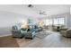 Cozy living room with comfortable seating, ceiling fan and an adjacent dining area at 1255 E Peppertree Dr # 507, Sarasota, FL 34242