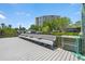 A long pier with seating overlooking the water, offering beautiful views of the building and boat docks at 1255 E Peppertree Dr # 507, Sarasota, FL 34242