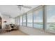 Sunny sun room features floor to ceiling windows with water views at 1255 E Peppertree Dr # 507, Sarasota, FL 34242