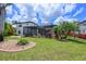 Spacious backyard featuring a screened pool, lush greenery, and well-maintained landscaping for serene outdoor living at 12644 20Th E St, Parrish, FL 34219