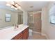 Bright bathroom featuring double sink vanity, walk-in shower, and neutral tiling at 12644 20Th E St, Parrish, FL 34219