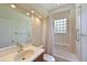 Clean bathroom with walk-in shower, tile surround, and vanity with ample lighting at 12644 20Th E St, Parrish, FL 34219