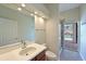 Well-lit bathroom with walk-in shower and sink with a view of the pool at 12644 20Th E St, Parrish, FL 34219