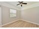 Bright bedroom with wood-look floors, a ceiling fan, and natural light at 12644 20Th E St, Parrish, FL 34219
