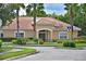Exterior of community clubhouse boasts a tile roof, well-maintained landscaping, and welcoming entrance at 12644 20Th E St, Parrish, FL 34219