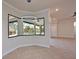 Light-filled dining area with a view of the pool and a modern pendant light at 12644 20Th E St, Parrish, FL 34219