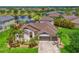Stunning lakefront home with lush landscaping, a paver driveway, and a spacious three-car garage at 12644 20Th E St, Parrish, FL 34219