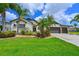 Beautiful home with lush landscaping, a well-kept lawn, and a convenient three-car garage at 12644 20Th E St, Parrish, FL 34219