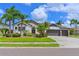 Charming home featuring a well-manicured lawn, stucco exterior, and a convenient three-car garage at 12644 20Th E St, Parrish, FL 34219
