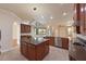 Expansive kitchen features stainless appliances, granite counters, and a large center island with seating at 12644 20Th E St, Parrish, FL 34219