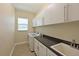 Bright laundry room with modern washer and dryer, ample cabinet space, and a convenient utility sink at 12644 20Th E St, Parrish, FL 34219