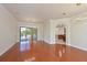 Open-concept living room showcases hardwood floors, stylish lighting, and access to the outdoor pool at 12644 20Th E St, Parrish, FL 34219