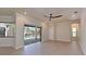 Bright living room with ceiling fan and sliding doors that open to the pool area at 12644 20Th E St, Parrish, FL 34219