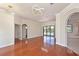 Elegant living room boasts hardwood floors, modern lighting, and seamless access to outdoor pool at 12644 20Th E St, Parrish, FL 34219