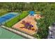 Aerial view of playground and tennis courts with colorful play structures and manicured green spaces at 12644 20Th E St, Parrish, FL 34219