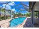 Sparkling screened-in pool and spa with lush landscaping, perfect for relaxation and outdoor enjoyment at 12644 20Th E St, Parrish, FL 34219