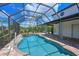 Inviting screened-in pool and spa area, surrounded by lush landscaping and a brick patio at 12644 20Th E St, Parrish, FL 34219