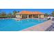Sparkling community pool with lounge chairs, tables, and chairs for relaxing and enjoying the sunshine at 12644 20Th E St, Parrish, FL 34219