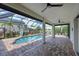 Inviting covered pool with a basketball hoop and lush landscaping offers a serene outdoor retreat at 12644 20Th E St, Parrish, FL 34219
