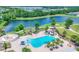 Aerial view of community amenities including a pool, splash pad, playground, and lake, all designed for active living at 12755 Rainwashed Loop, Parrish, FL 34219